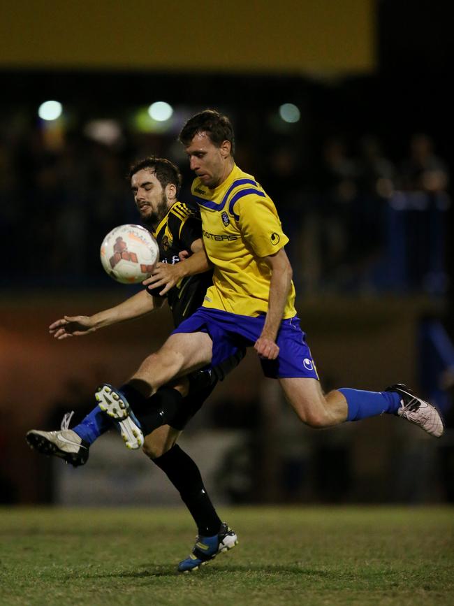 Gold Coat Premier League Soccer Final between Mudgeeraba and Broadbeach United. Mudgeeraba's Shane Billings and Broadbeach's Timothy Kerwick. Picture by Scott Fletcher