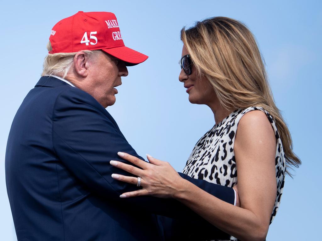The US President and First Lady embraced in front of the rally crowd. Picture: Brendan Smialowski / AFP.