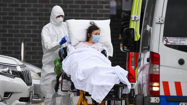 Ambulance officers transfer a resident from the Epping Gardens aged-care facility in the Melbourne suburb of Epping in 2020. Picture: AFP