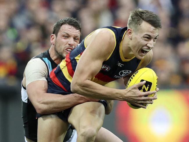 04/08/18 - AFL - Showdown 45 - Adelaide Crows v Port Adelaide at Adelaide Oval. Travis Boak tackles Tom Doedee. Picture SARAH REED