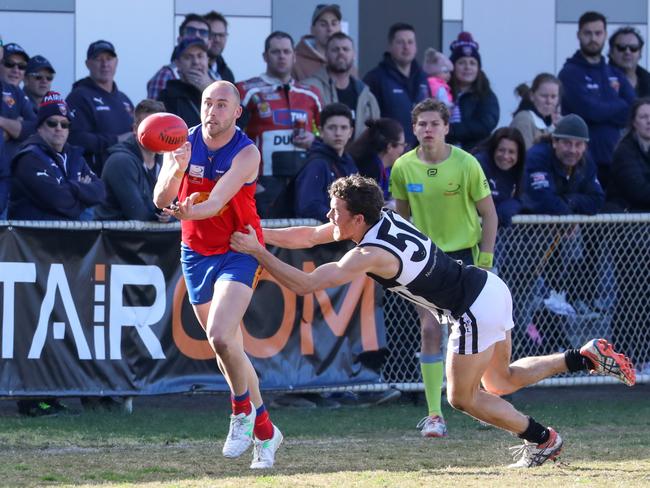 Brad Nied fires out a handball. Picture: Craig Dooley