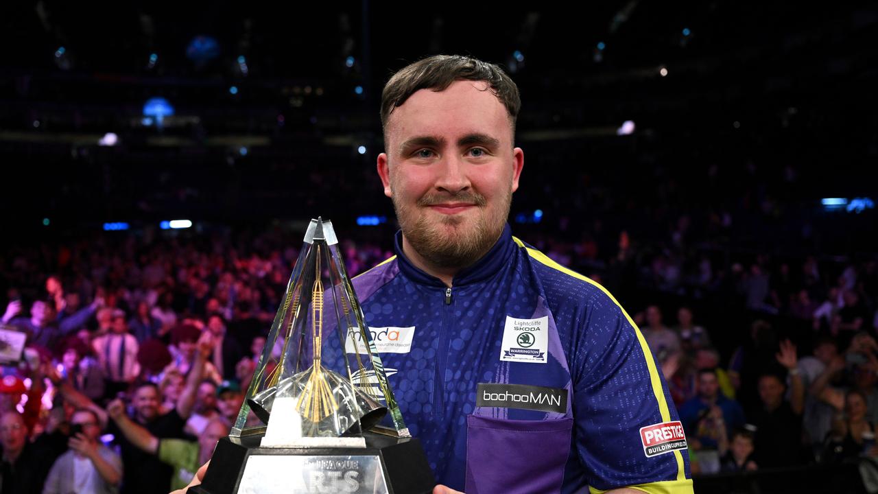 LONDON, ENGLAND - MAY 23: Luke Littler of England celebrates with the trophy after winning the Final match against Luke Humphries of England at the 2024 BetMGM Premier League Darts Play-Offs at The O2 Arena on May 23, 2024 in London, England. (Photo by Justin Setterfield/Getty Images)