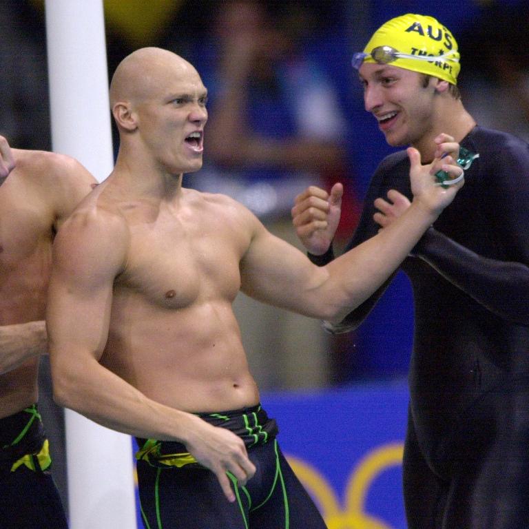 Australian swimmer Michael Klim plays air guitar after teammate Ian Thorpe swam the final leg in the 4x100m freestyle relay to bring home gold for the Aussies ahead of the US team. Picture: Darren England/ALLSPORT