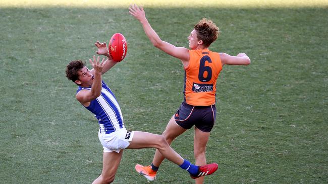 Kangaroo Curtis Taylor takes a mark in front of GWS’s Lachie Whitfield at Homebush on Sunday. Picture: Toby Zerna