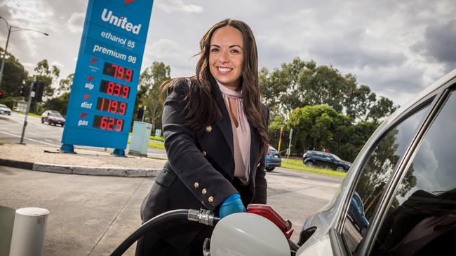 Adele Mirabella fills up with cheap fuel at a United Petrol Station in Kew in April. Picture: Jake Nowakowski