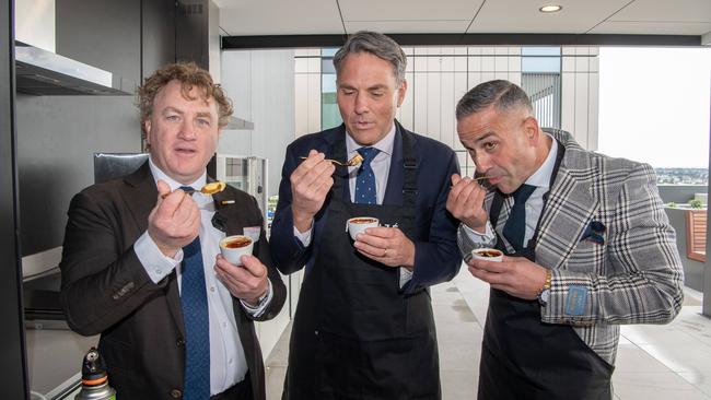 Chef Adrian Richardson, Deputy Prime Minister Richard Marles and developer Paul Franze taste the creme brulee. Picture: Brad Fleet