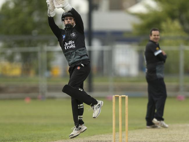 Karl Mayne climbs high to reel in a throw from the outfield for Brunswick. Picture: Valeriu Campan.