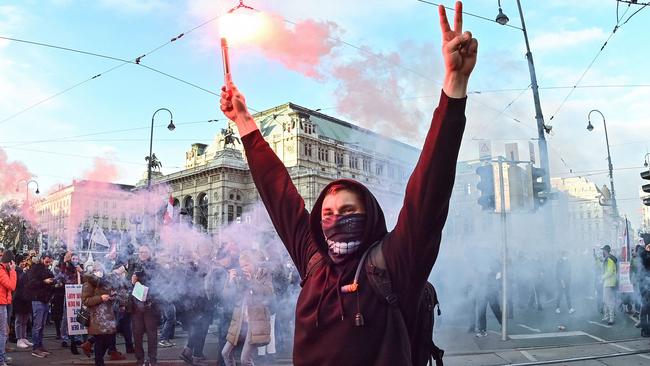 Demonstrators light flares at a by Austria's far-right Freedom Party against coronavirus restrictions. Picture: AFP