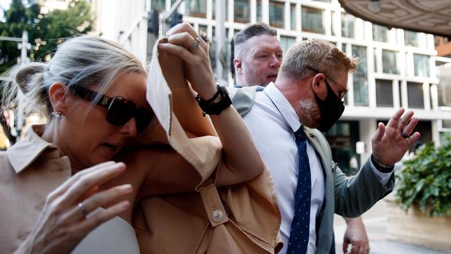 Holston (black mask) arrives at the Downing Centre District Court on Thursday with two supporters. Picture: NCA NewsWire / Nikki Short