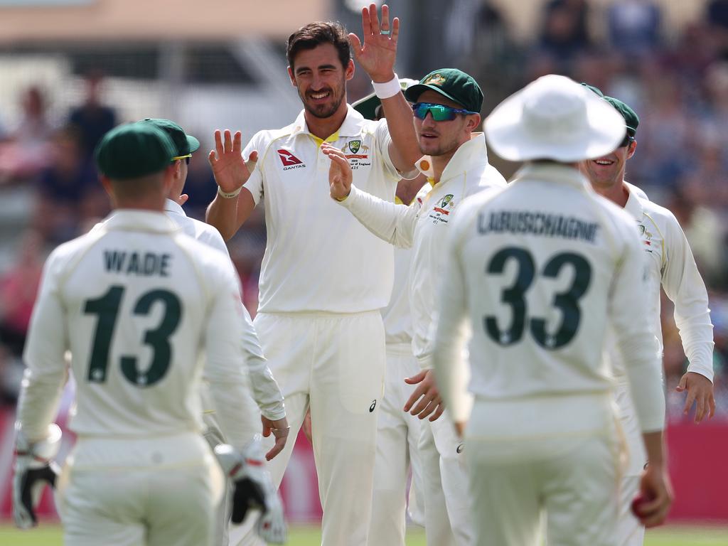 Mitchell Starc is congratulated on the wicket of Callum Ferguson. (Photo by Matthew Lewis/Getty Images)
