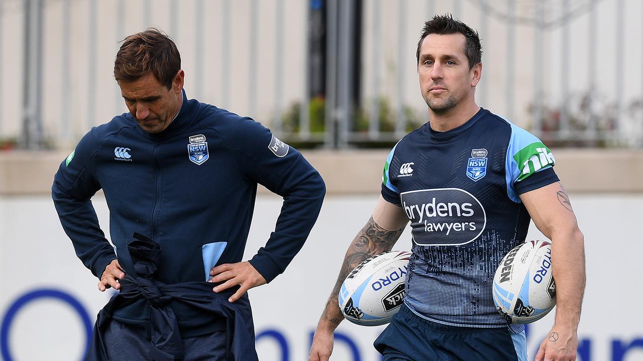 Mitchell Pearce (right) speaks with Andrew Johns during a training session