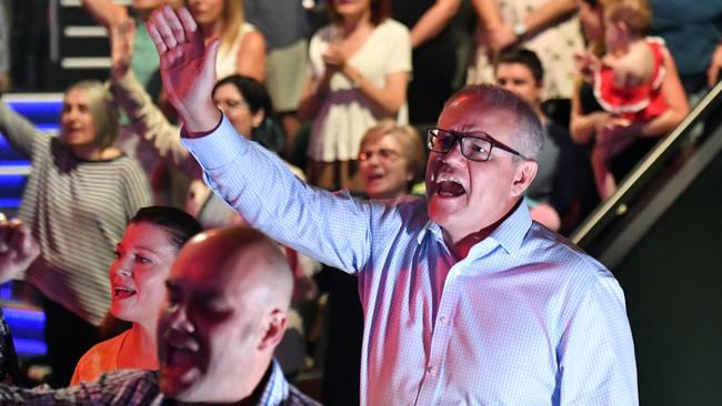 Prime Minister Scott Morrison and wife Jenny sing during an Easter Sunday service at his Horizon Church at Sutherland in Sydney.