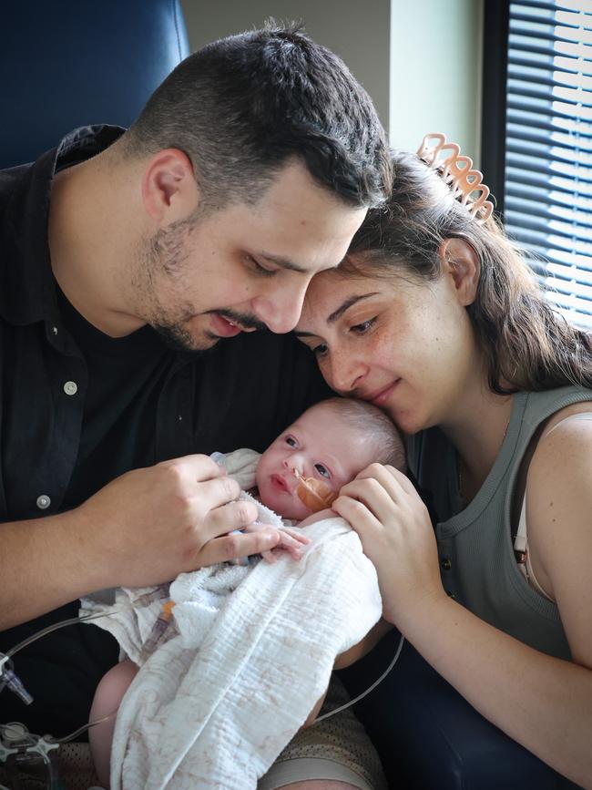 Young Zoe enjoying some cuddle time with her parents Nicholas and Cristy Loizou out of the crib. Picture: David Caird