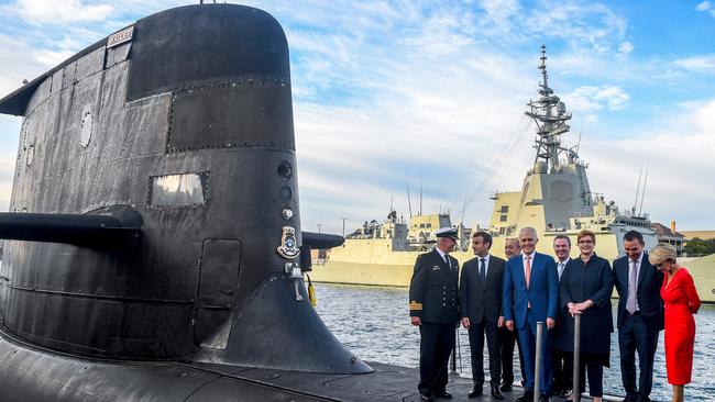 French President Emmanuel Macron (2/L) and then Prime Minister Malcolm Turnbull (C) standing on the deck of HMAS Waller, a Collins-class submarine operated by the Royal Australian Navy, at Garden Island in Sydney in 2018.