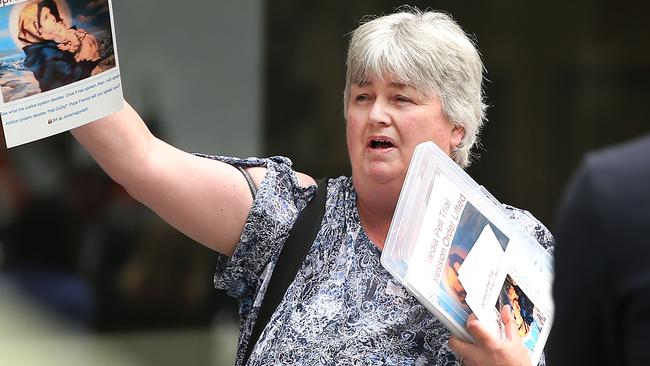 Opponents of Cardinal George Pell react after he left court today. Picture: Michael Dodge/Getty