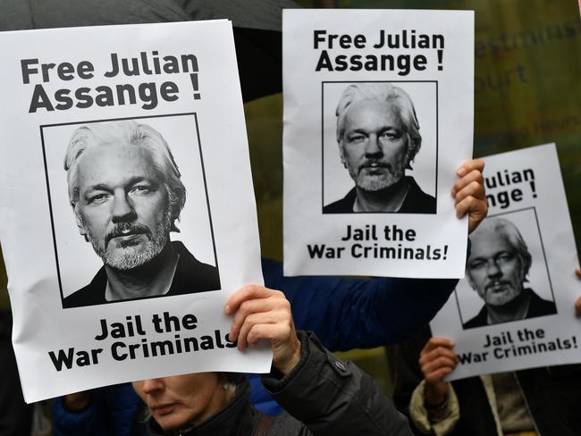 Demonstrators hold banners calling for WikiLeaks founder Julian Assange to be freed and not extradited to the US outside Westminster Magistrates Court in London. Picture: AFP