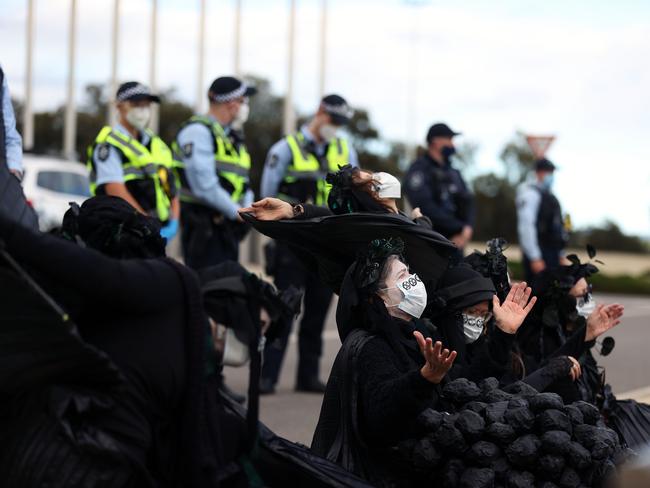 Police watched on as protesters pretended to bury children's bodies. Picture: Gary Ramage / NCA NewsWire