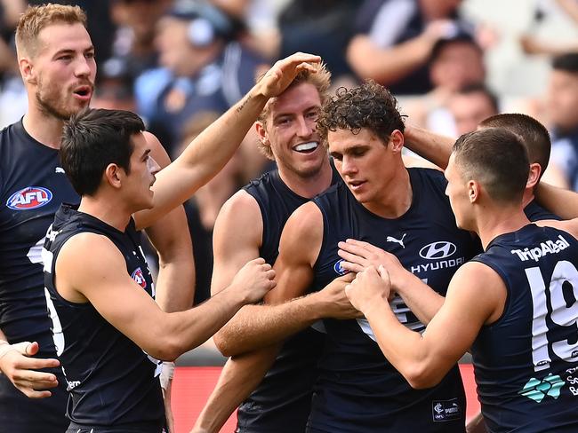 MELBOURNE, AUSTRALIA - APRIL 17: Charlie Curnow of the Blues is congratulated by team mates after kicking a goal during the round five AFL match between the Carlton Blues and the Port Adelaide Power at Melbourne Cricket Ground on April 17, 2022 in Melbourne, Australia. (Photo by Quinn Rooney/Getty Images)