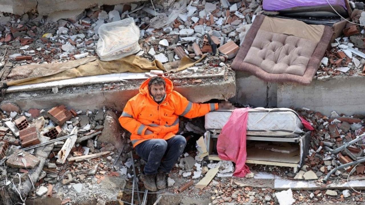 Mesut Hancer holds the hand of his 15-year-old daughter Irmak, who died in the earthquake in Kahramanmaras, close to the epicentre. Picture: AFP.