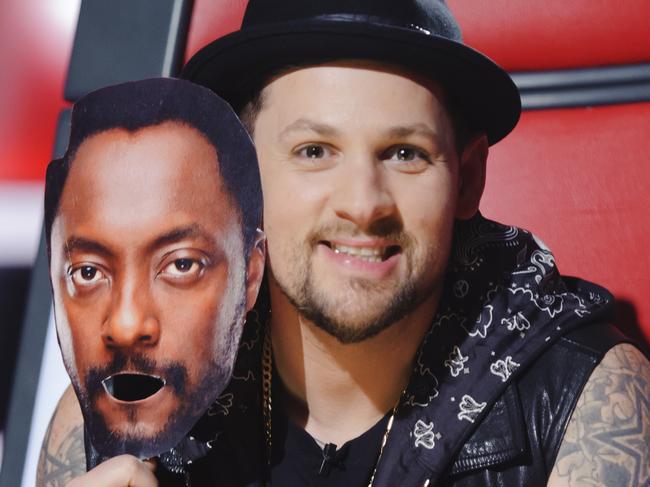 The Voice coach Joel Madden pulls on a will.i.am mask during the blind auditions. Pic supplied/Nine.