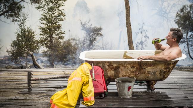 Simon Crisp had battled to save his own property in Longwood East from a rampaging fire with the help of the CFA. When the danger was over he took a well earned bath and beer. Picture: Jason Edwards