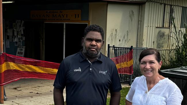 Wujal Wujal mayor Bradley Creek and Communities Minister Leanne Enoch stand outside the community store which was badly damaged during the Far North floods.