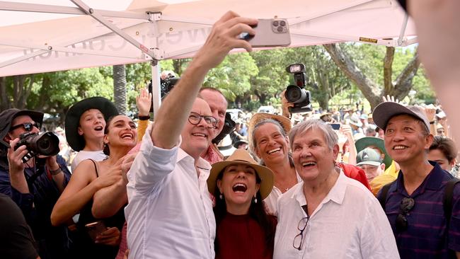 Anthony Albanese taking selfies with voice supporters on friendly home ground.