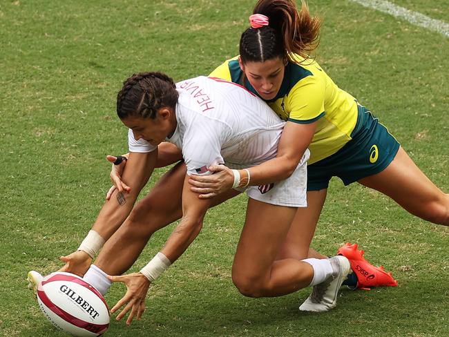 CHOFU, JAPAN - JULY 30:  Nicole Heavirland of Team United States is tackled by Charlotte Caslick of Team Australia in the WomenÃ¢â¬â¢s pool C match between Team Australia and Team United States during the Rugby Sevens on day seven of the Tokyo 2020 Olympic Games at Tokyo Stadium on July 30, 2021 in Chofu, Tokyo, Japan. (Photo by Dan Mullan/Getty Images)