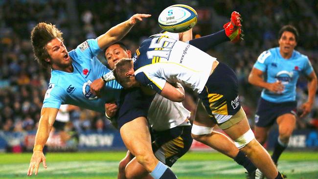 SYDNEY, AUSTRALIA - JUNE 28: Rob Horne of the Waratahs offloads in a tackle during the round 17 Super Rugby match between the Waratahs and the Brumbies at ANZ Stadium on June 28, 2014 in Sydney, Australia. (Photo by Mark Nolan/Getty Images)