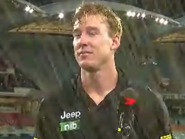 Tom Lynch is soaked by a drink thrown by a fan.