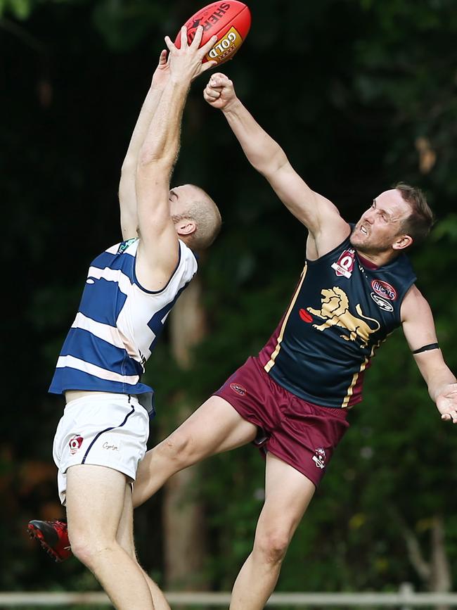 Brad Wallace punches the ball from Adam Gross' hands as he takes a mark. PICTURE: BRENDAN RADKE.