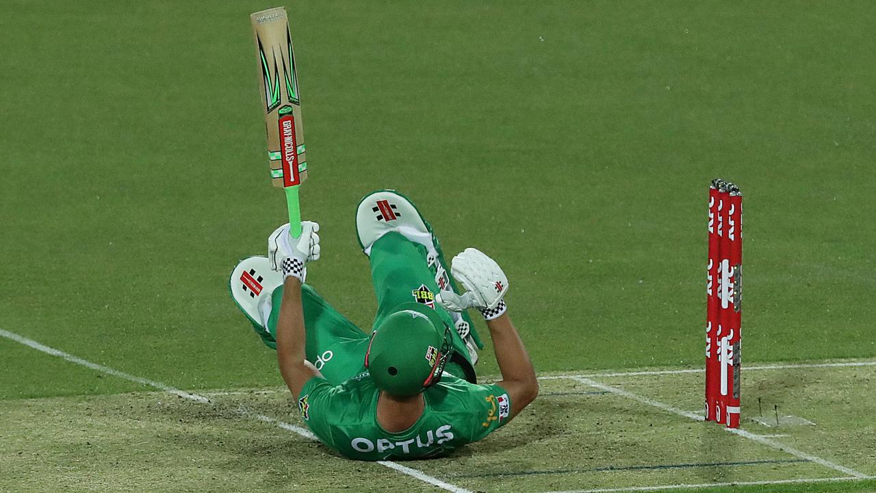 Marcus Stoinis falls after he was rocked by a Riley Meredith short ball.