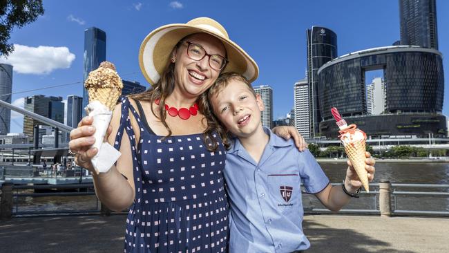 Beatrice and Jessie Andrews enjoying time by the Brisbane River at Southbank. They’d love for the school holidays to be on during the Olympics. Picture: Richard Walker