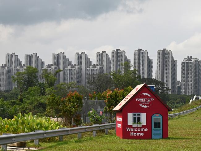 This picture taken on April 22, 2019 shows a signboard in the shape of a house welcoming visitors to the Forest City housing project in Malaysia's southern state of Johor Baru. With two-thirds of units sold to mainland Chinese buyers well before the 100 billion USD project is completed in 2035, Forest City became a lightning rod for anger at growing Chinese influence in Malaysia during elections last year. (Photo by Roslan RAHMAN / AFP) / TO GO WITH China-diplomacy-trade-Malaysia-Sri Lanka-Philippines,FOCUS by Poornima WEERASEKARA