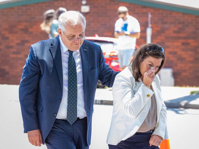 Mr Morrison comforts his wife as they leave the flower memorial. Picture: Jason Edwards