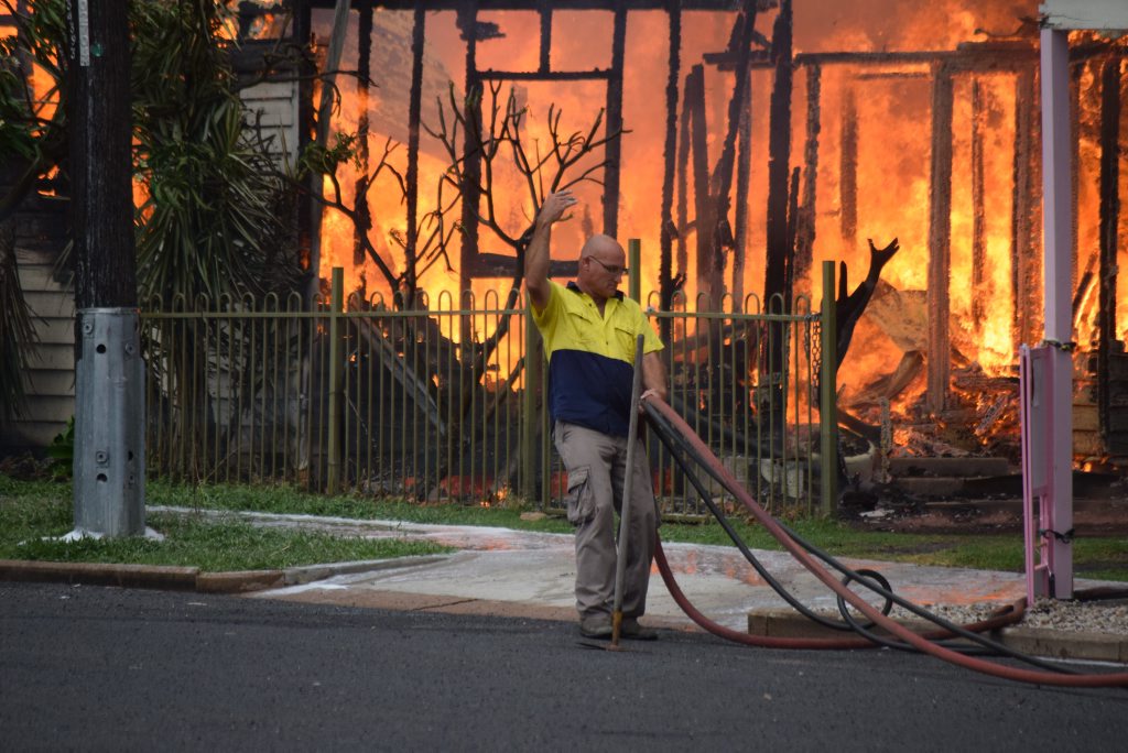 A passerby helps fight the fire. Picture: Alasdair Young