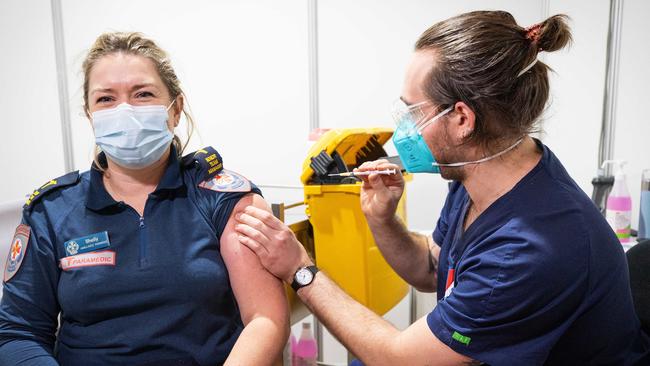 Paramedic Shelly Tennant receives her second does of the AstraZeneca Covid19 vaccine from Dillon Di Fabrizio at the Royal Exhibition Building, Melbourne. Picture: Mark Stewart