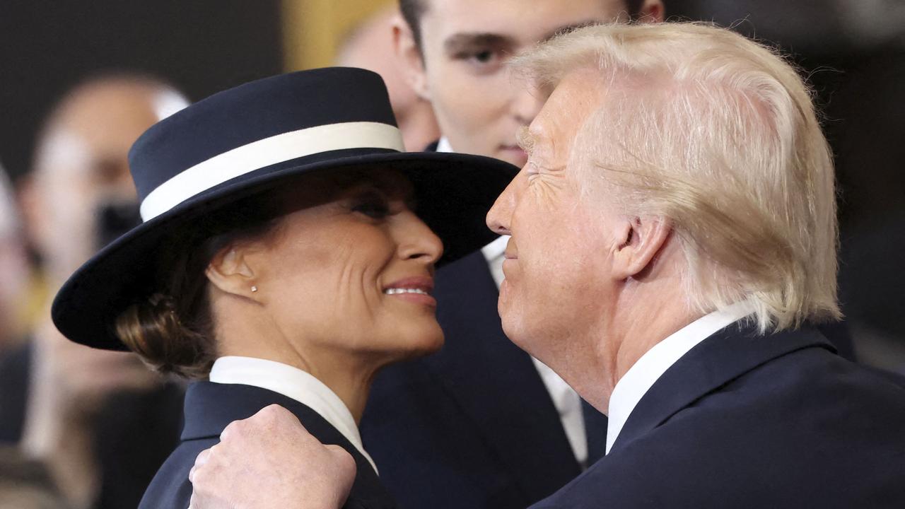 US President Donald Trump and First Lady Melania Trump embrace after he was sworn in inside the Rotunda of the US Capitol.