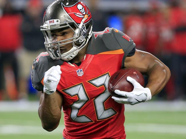 This Dec. 18, 2016 photo shows Tampa Bay Buccaneers' Doug Martin (22) carrying the ball in the first half of an NFL football game against the Dallas Cowboys in Arlington, Texas. Martin has been suspended four games for violating the NFL's policy on performance enhancing substances and said Wednesday, Dec. 28, 2016 he's entering a treatment facility rather than appeal the ban. (AP Photo/Ron Jenkins)