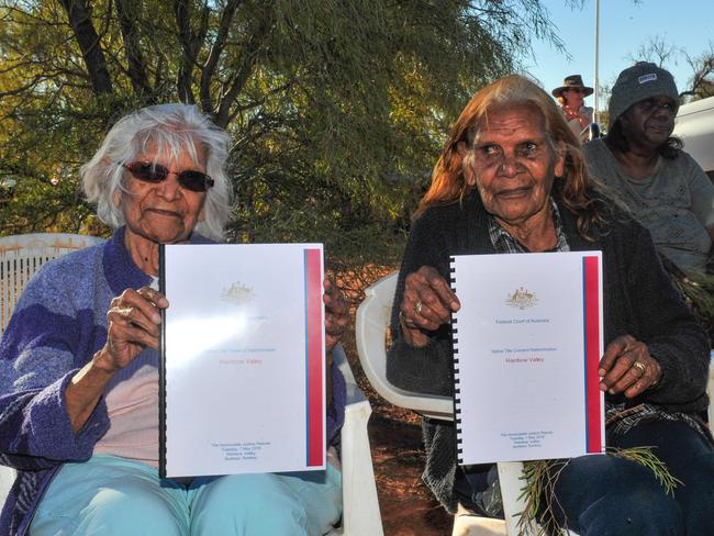 Two senior Aboriginal women holding copies of the Native Title Consent Determination Picture: SATRIA DYER-DARMAWAN