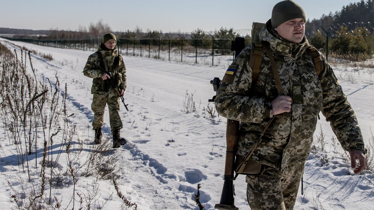 Members of the Ukrainian Border Guard patrol along the Ukrainian border fence at the Three Sisters border crossing between, Ukraine, Russia and Belarus. Picture: Chris McGrath/Getty Images