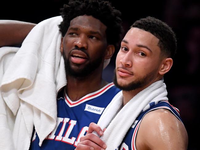 LOS ANGELES, CALIFORNIA - JANUARY 29: Ben Simmons #25 and Joel Embiid #21 of the Philadelphia 76ers watch play in the final minutes during a 121-105 win over the Los Angeles Lakers at Staples Center on January 29, 2019 in Los Angeles, California. NOTE TO USER: User expressly acknowledges and agrees that, by downloading and or using this photograph, User is consenting to the terms and conditions of the Getty Images License Agreement.   Harry How/Getty Images/AFP == FOR NEWSPAPERS, INTERNET, TELCOS & TELEVISION USE ONLY ==