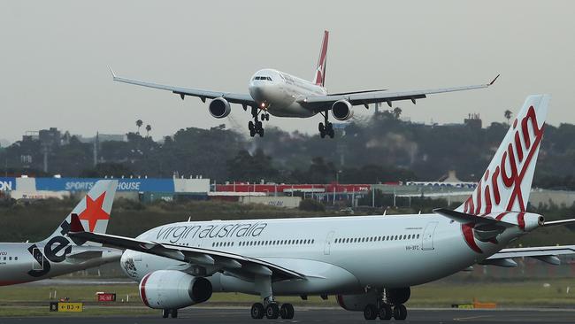 Travel is also likely to suffer as Australians shift their spending back towards buying goods. Photographer: Brendon Thorne/Bloomberg.