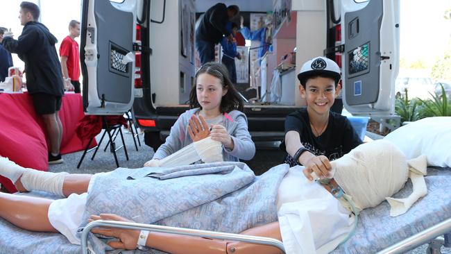 Elli Sharp, 7, from Nerang and Darius Taiy, 10, from Robina have a go at first aid. Picture: Glenn Hampson