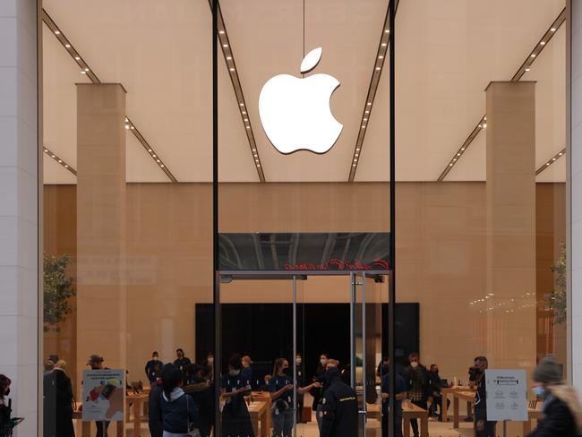 BERLIN, GERMANY - FEBRUARY 15: People walk past a recently-opened Apple Store during the Omicron wave of the novel coronavirus wave on February 15, 2022 in Berlin, Germany. Many states in Germany are reporting a peak in Omicron infections, which combined with the currently low Covid hospitalization rate, is leading both state and federal governments to work towards phasing in reductions in coronavirus-related restrictions. Specifically, authorities plan to drop the current "2G" mandate that bans people who are not vaccinated from many public places, including museums, restaurants and non-essential shops, replacing it with a required recent negative test result and leaving in place the requirement to wear an FFP2 mask.  (Photo by Sean Gallup/Getty Images)