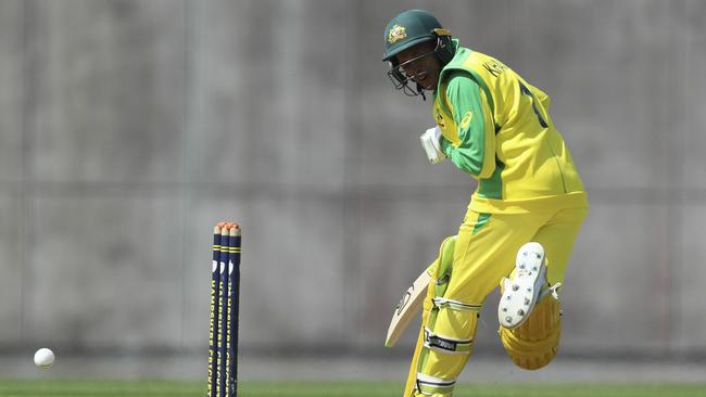 Usman Khawaja is rocked by an Andre Russell bouncer.