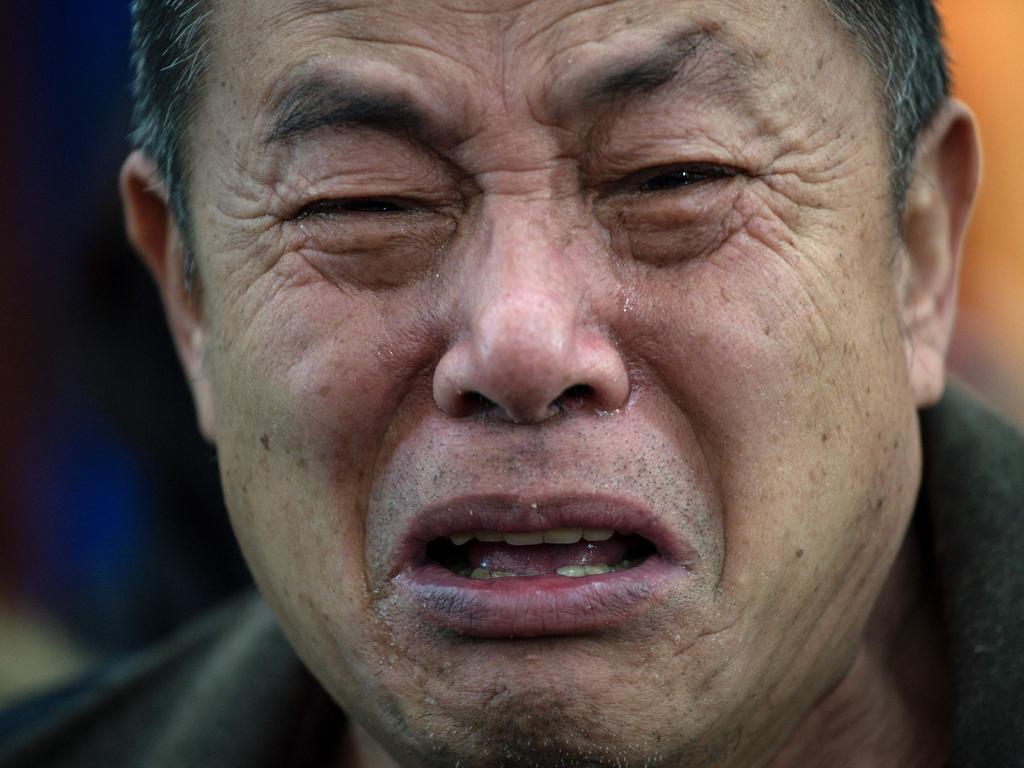 A relative of missing Chinese passengers aboard MH370 reacting to the suspension of the MH370 search in January 2017. Picture: