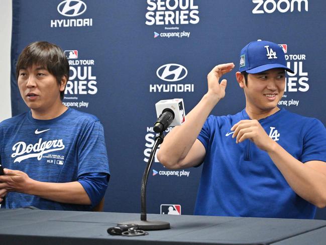 TOPSHOT - This picture taken on March 16, 2024 shows Los Angeles Dodgers' Shohei Ohtani (R) and his interpreter Ippei Mizuhara (L) attending a press conference at Gocheok Sky Dome in Seoul ahead of the 2024 MLB Seoul Series baseball game between Los Angeles Dodgers and San Diego Padres. The Los Angeles Dodgers said on March 21 they had fired Shohei Ohtani's interpreter after the Japanese baseball star's representatives claimed he had been the victim of "a massive theft" reported to involve millions of dollars. (Photo by Jung Yeon-je / AFP)