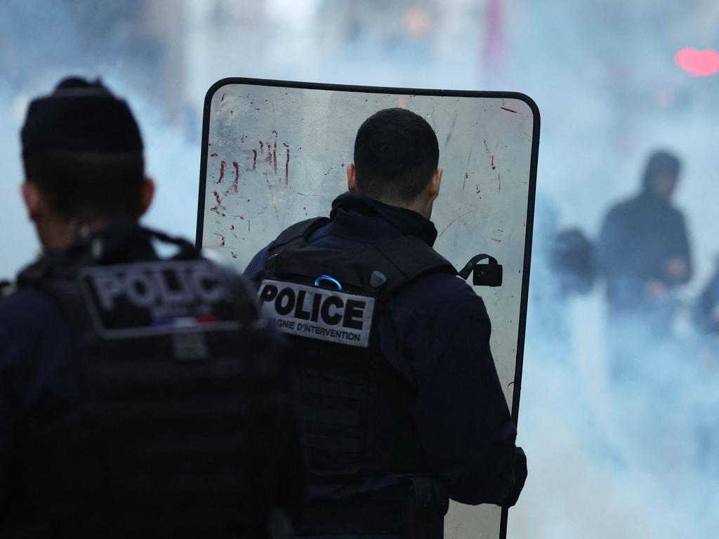 French riot police officers run to disperse protesters during a clash following a statement by French Interior Minister at the site where several shots were fired along rue d'Enghien in the 10th arrondissement, in Paris. Picture: AFP