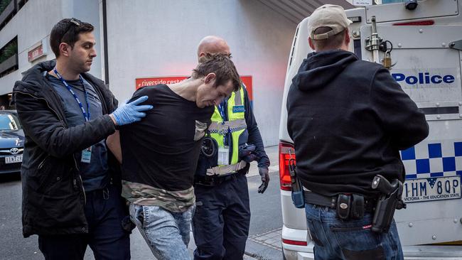 The man is led away by police. Picture: Jake Nowakowski. Picture: Jake Nowakowski